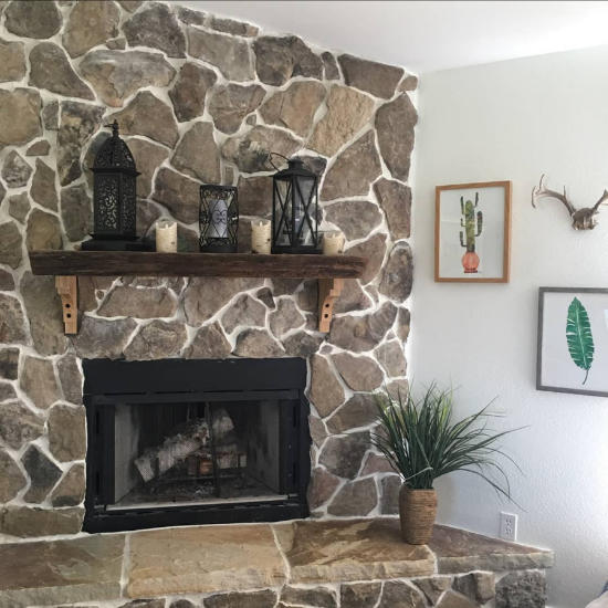 An indoor fireplace made of natural stone.